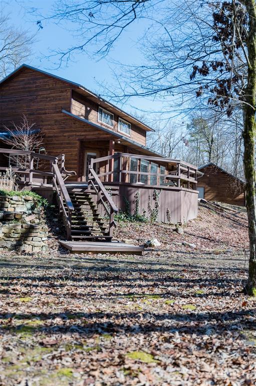 rear view of house featuring a wooden deck