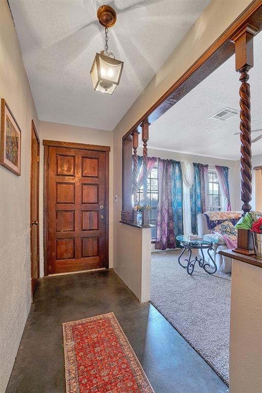 foyer featuring a textured ceiling and a healthy amount of sunlight