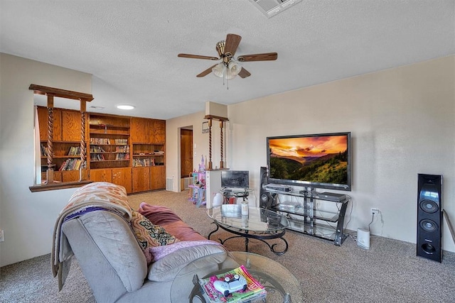 carpeted living room featuring ceiling fan and a textured ceiling