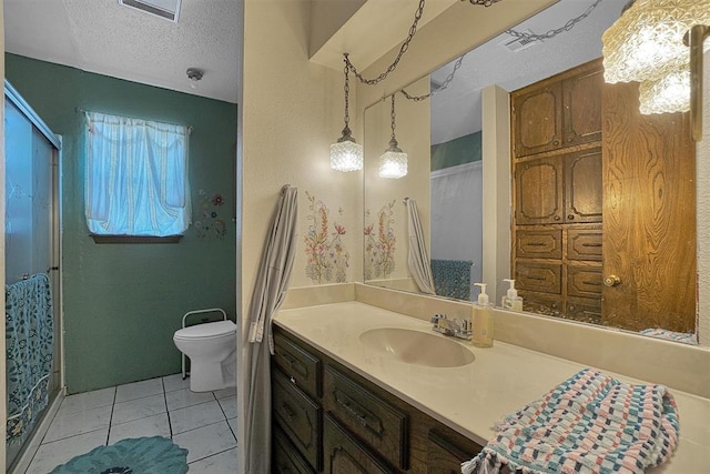 bathroom with vanity, tile patterned floors, a textured ceiling, and toilet