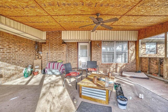 unfurnished sunroom with ceiling fan