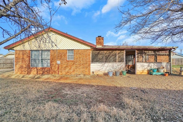 rear view of house with a sunroom