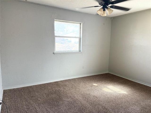 carpeted spare room with baseboards, a textured ceiling, and a ceiling fan