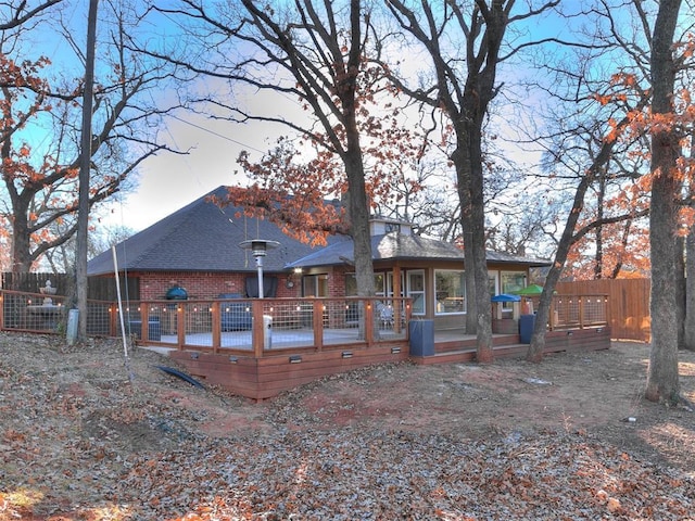 back of house with a deck