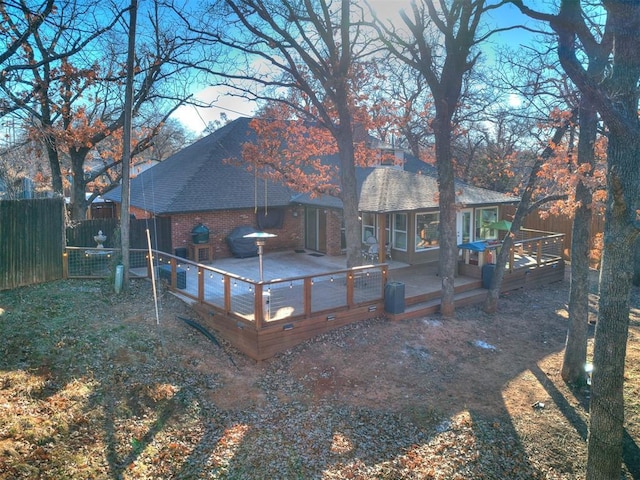 back of property featuring a wooden deck