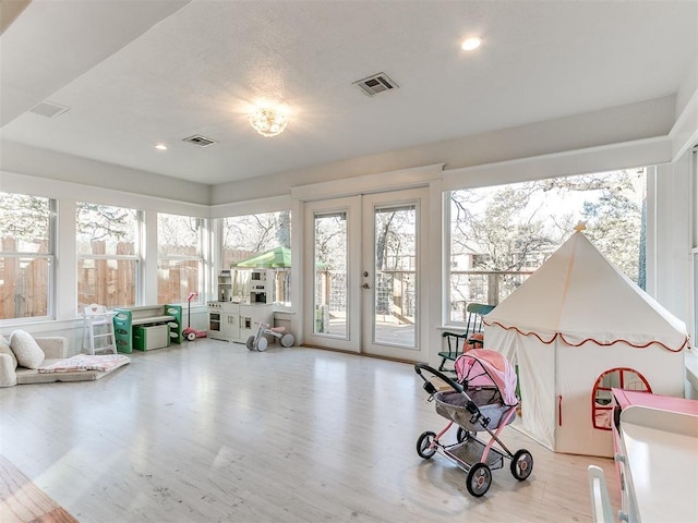 interior space featuring french doors and light hardwood / wood-style flooring