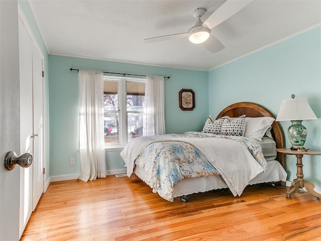 bedroom featuring crown molding, ceiling fan, and light hardwood / wood-style floors