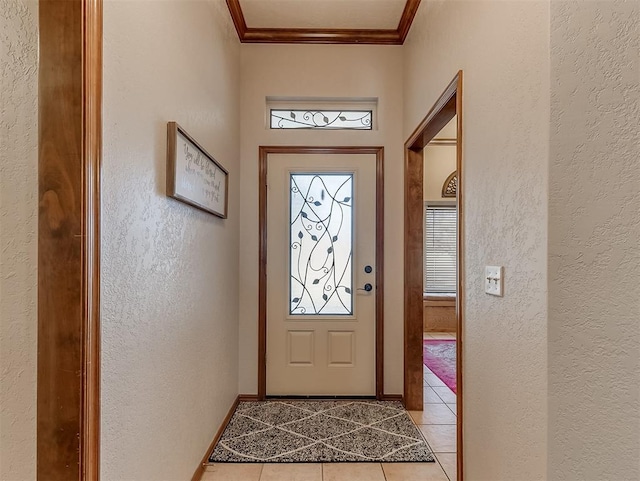 entryway featuring ornamental molding and light tile patterned floors