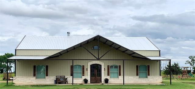 view of front facade with a front yard and a playground