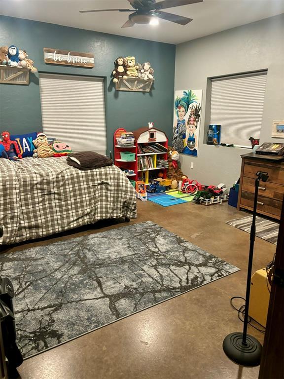 bedroom with concrete floors and ceiling fan