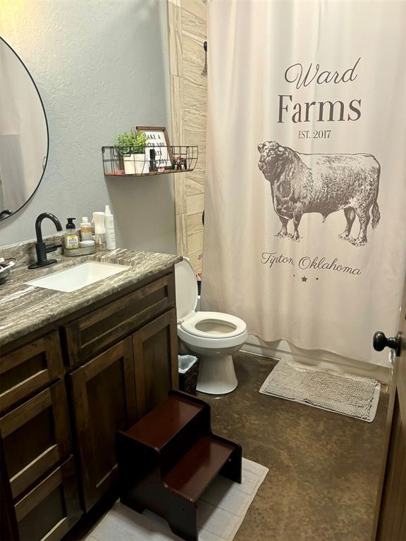 bathroom featuring vanity and toilet