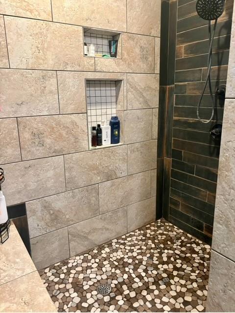 bathroom with a tile shower