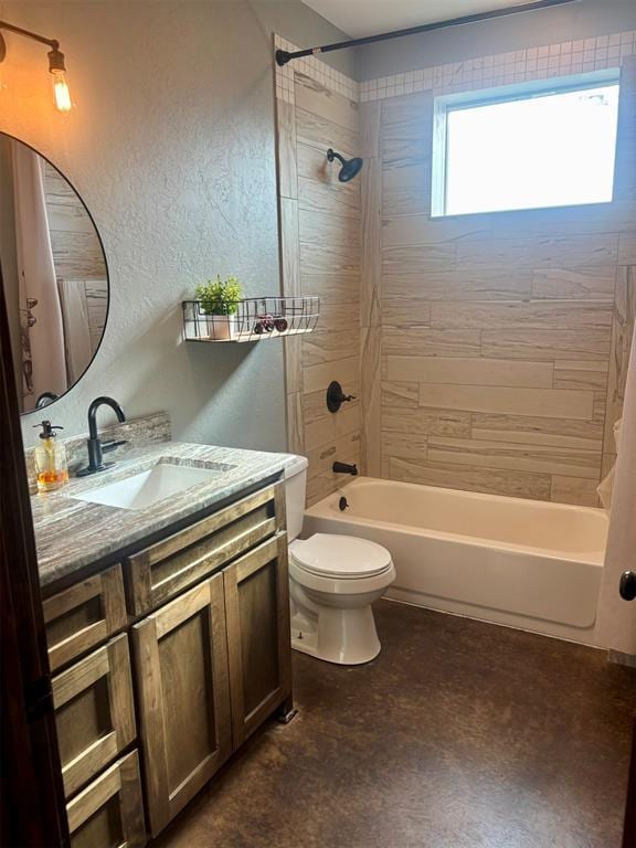 full bathroom featuring vanity, tiled shower / bath combo, and toilet