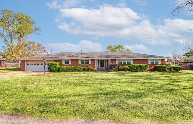 ranch-style house featuring a garage and a front yard