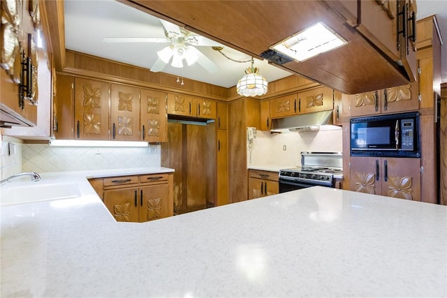 kitchen featuring backsplash, sink, ceiling fan, and range