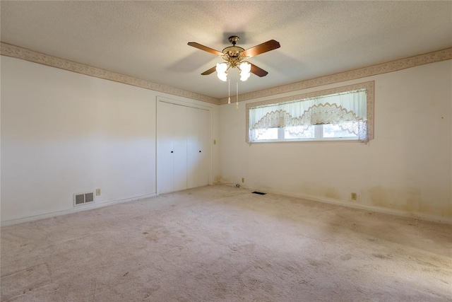 empty room featuring light carpet and ceiling fan