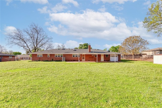 back of property with a lawn