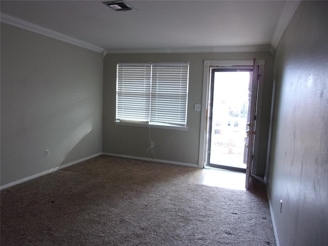 empty room with crown molding and carpet