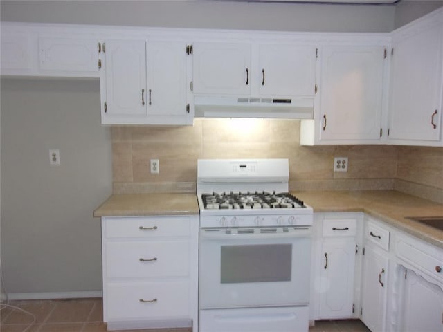 kitchen featuring white cabinetry, white range with gas stovetop, backsplash, and light tile patterned floors