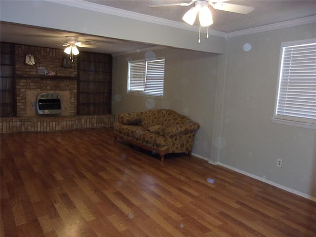 sitting room with hardwood / wood-style flooring, ornamental molding, heating unit, and ceiling fan