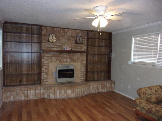 unfurnished living room featuring heating unit, crown molding, a fireplace, and a textured ceiling