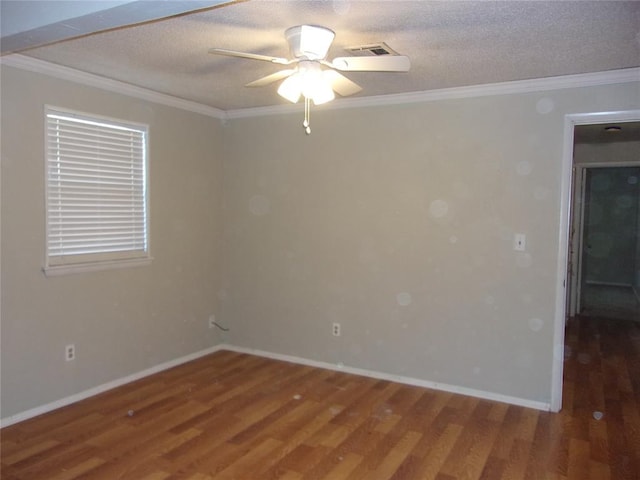 spare room featuring ornamental molding, dark wood-type flooring, a textured ceiling, and ceiling fan