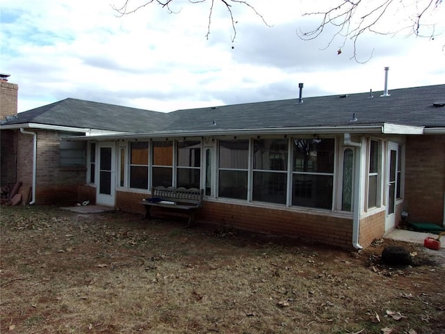 back of house featuring a sunroom