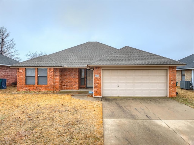 single story home with a garage and cooling unit