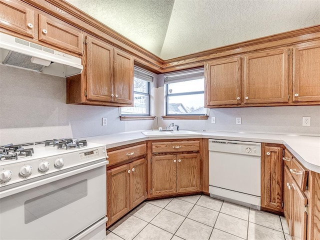 kitchen with lofted ceiling, sink, a textured ceiling, light tile patterned floors, and white appliances