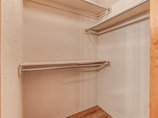 spacious closet featuring hardwood / wood-style flooring