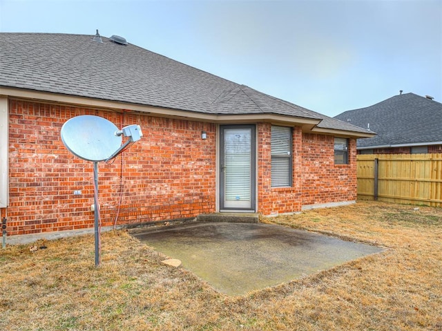 rear view of property featuring a patio area and a lawn