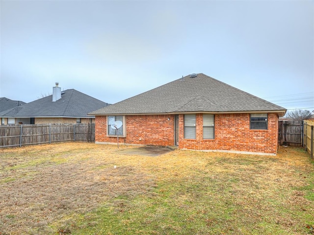 rear view of property featuring a patio and a lawn