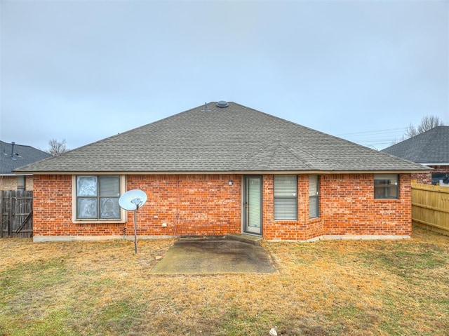 rear view of house featuring a patio area and a lawn