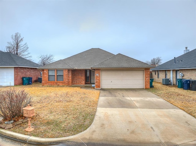 single story home featuring central AC and a garage