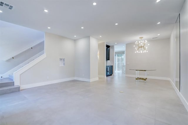 unfurnished living room with an inviting chandelier