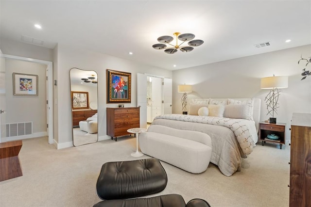 bedroom with connected bathroom and light colored carpet