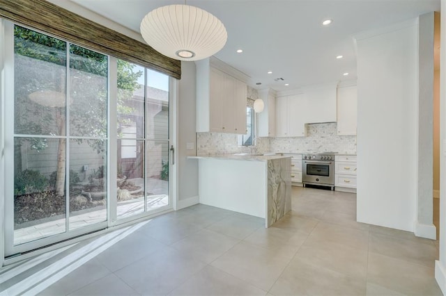 kitchen featuring tasteful backsplash, pendant lighting, white cabinets, and wall oven