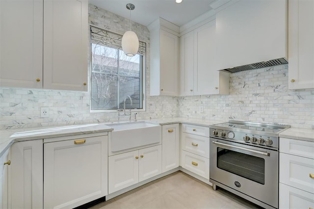 kitchen with pendant lighting, white cabinetry, sink, high end stainless steel range oven, and light stone counters