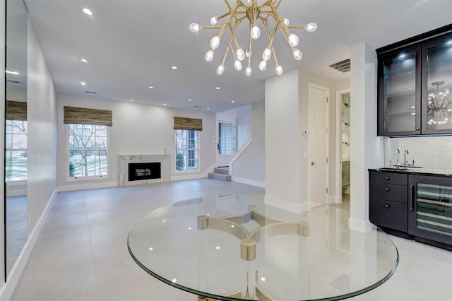 living room with a fireplace, beverage cooler, and indoor bar