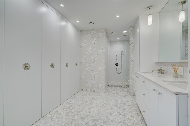 bathroom with vanity and tiled shower