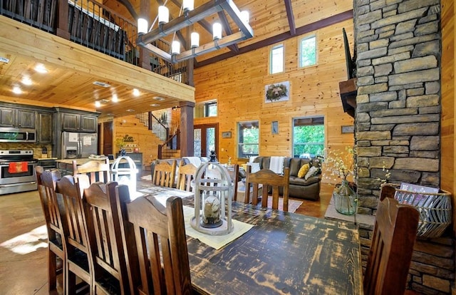 tiled dining area with wood walls, a high ceiling, and wooden ceiling