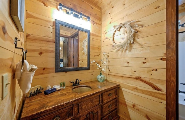 bathroom featuring vanity and wood walls