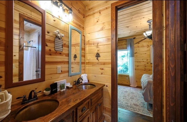 bathroom featuring vanity, hardwood / wood-style floors, and wood walls