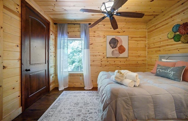 bedroom featuring wood ceiling, ceiling fan, wooden walls, and dark hardwood / wood-style flooring