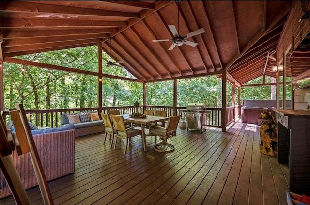 sunroom / solarium with ceiling fan and vaulted ceiling