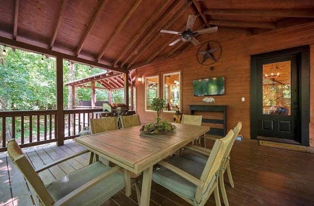 sunroom featuring vaulted ceiling with beams