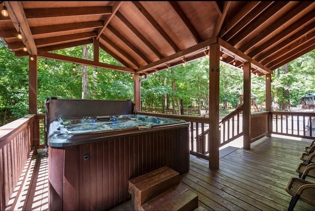 deck with a hot tub and a gazebo