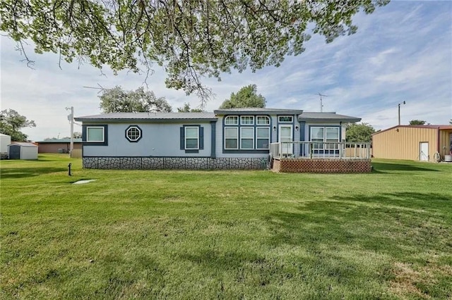 back of house featuring a yard and a deck