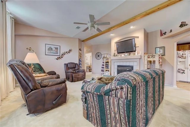 living room with light colored carpet, a fireplace, lofted ceiling with beams, and ceiling fan