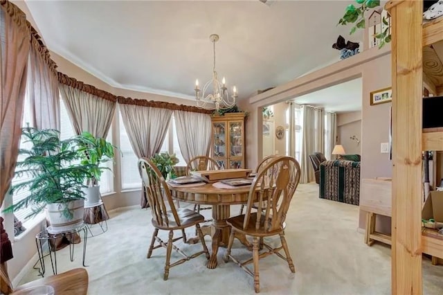 carpeted dining room with a chandelier